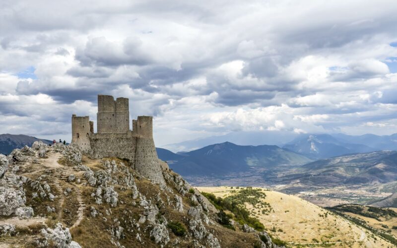 Stunning view of Rocca Calascio castle perched on a hilltop in Abruzzo under dramatic skies.